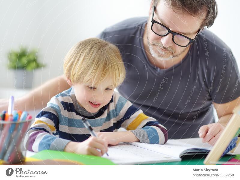 Father helping child do his homework at home. Tutor teaching boy with ADHD. Education for kids. homeschooling hyperactive adhd family teacher tutor dissatisfied