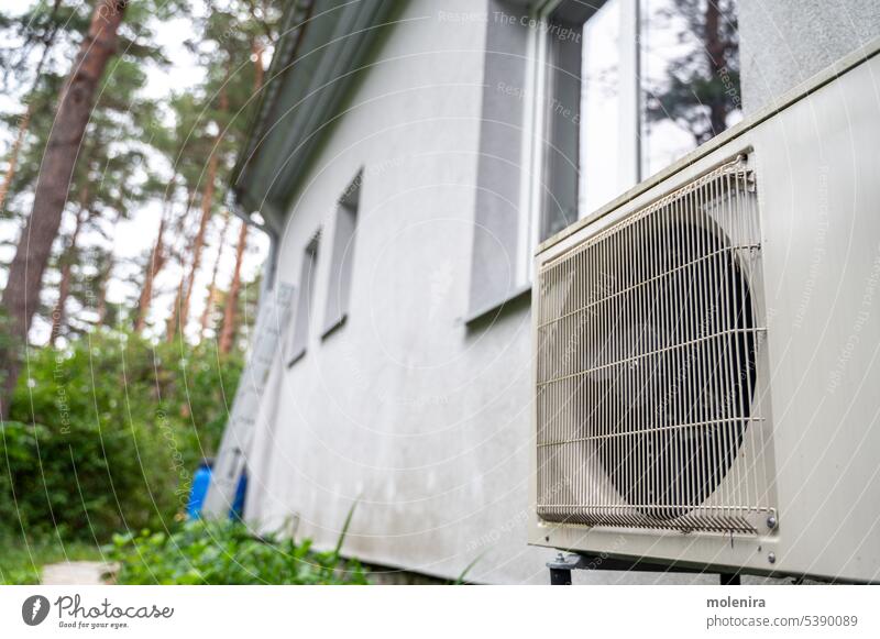 Heat pump outside of residential house conditioning heat fan system unit electric air energy cooling home compressor ac equipment conditioner air conditioning