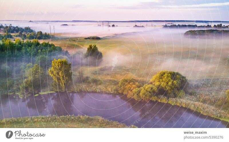 Aerial view of rural landscape with river and lush trees in fog morning sunrise summer panorama mist nature scenic water cloud beautiful forest dawn sky sunset