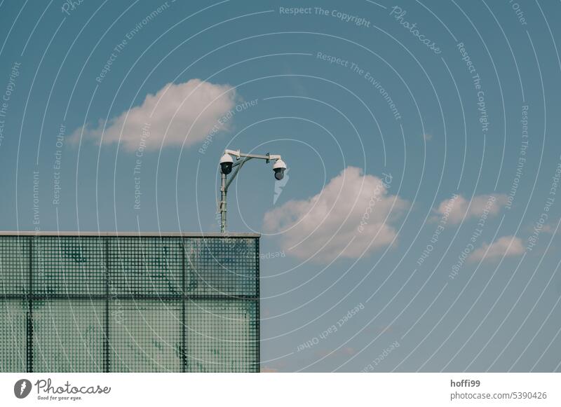 Surveillance camera on the roof of factory building against blue sky Video camera minimalism Safety Technology Observe Surveillance device Testing & Control