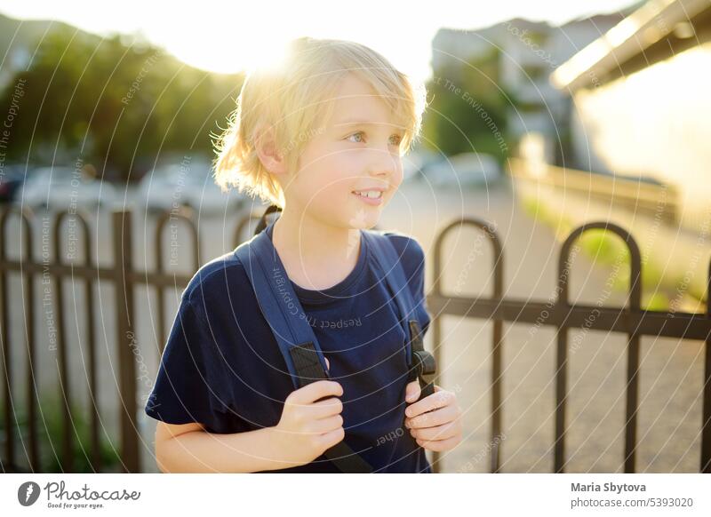 Portrait of cute preteen boy in the city at sunset. Happy child is going to school. kids portrait back to school street positive student backpack caucasian