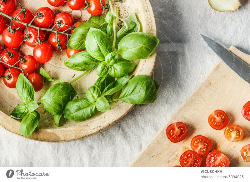 Cooking with tomatoes and basil , top view cooking above overhead italian food ingredients leaves herb vegetarian table raw healthy fresh green wooden