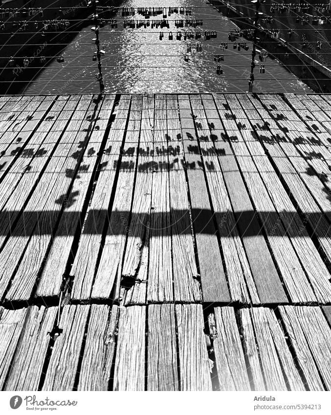 Love locks on canal bridge cast shadows on wooden walkway b/w Love Locks Bridge Shadow play Footbridge Wood Channel Water Hamburg Harbour Evening Light rail