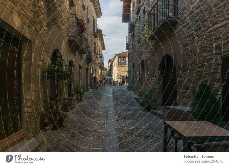 Street with stone houses in the medieval village of Ainsa in the pyrenees, Aragon, Spain ainsa ancient huesca spain street architecture old building travel wall