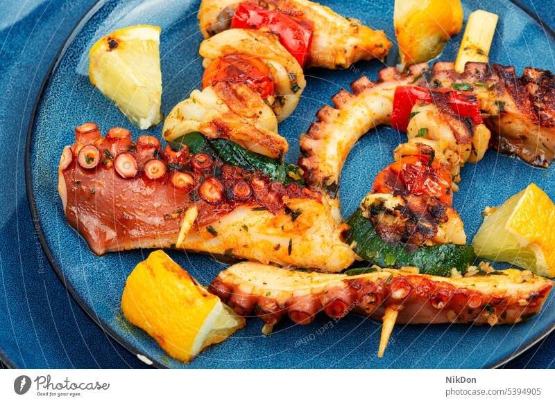 Octopus skewers, sea delicacy. octopus kebab grilled tentacle squid seafood grilled octopus octopus tentacle mollusc calamary shish kebab barbecue close up