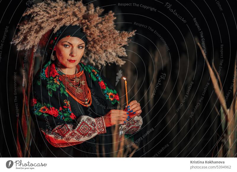 Mysterious ukrainian woman with candle, she in traditional costume outdoors attractive beautiful beauty clothes confident culture dress embroidered shirt