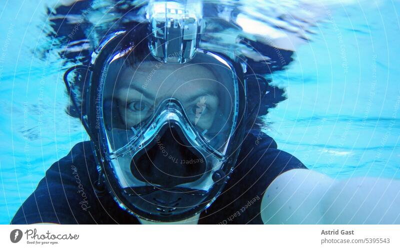 Underwater photo of woman with diving goggles Woman Dive underwater Ocean Water Diving goggles Snorkeling vacation Sea water Sports Athletic underwater glasses