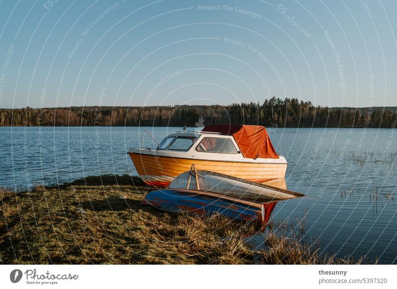 Boat in the lake boat wooden boat Lake Lakeside Sunlight Shadow Canoe tranquillity Peace Nature Blue sky blue lake yellow boat