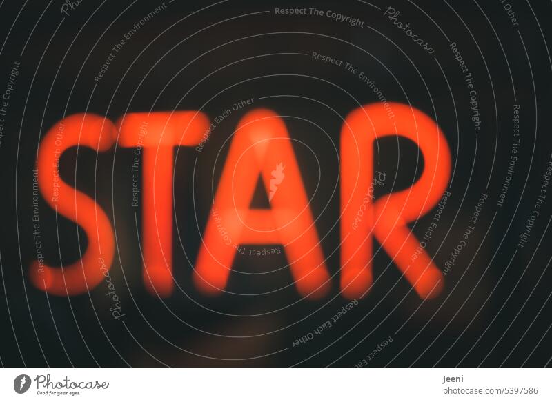 star Starling famous Celebrity Business Shows Television movie Music Light Word Red Letters (alphabet) Text Signs and labeling Illuminate hazy Advertising