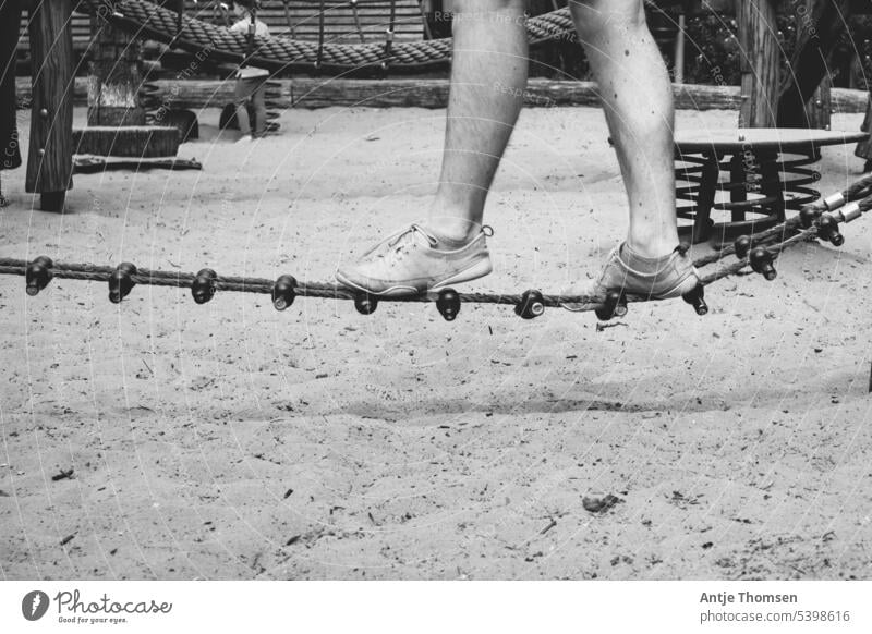 Person balancing over a rope on the playground balance Playground Legs Balance balancing act Human being Movement Summer
