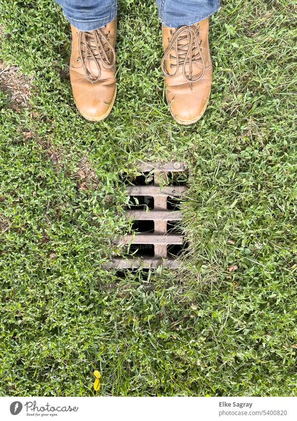 Water drainage grate in grass Grating Footwear Colour photo Metal Structures and shapes Pattern Abstract Protection Exterior shot Construction Safety