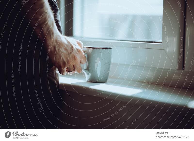 Silence - man with coffee in hand waits and looks through window Wait Man Meditative tranquillity Break Coffee cup Hand Coffee break view outside Window
