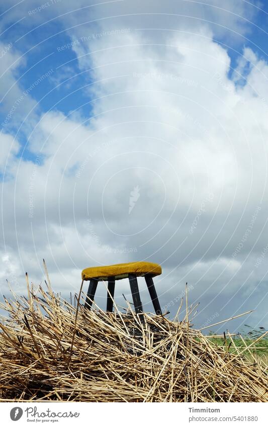 A stool on the road... Stool padding Cloth Yellow Stool legs Wood Black Hill Straw Sky Clouds Beautiful weather Denmark Old