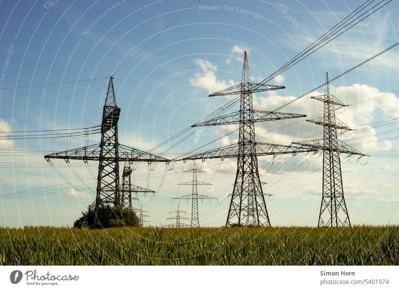 Power poles in a field pylon transmission line Electricity pylon Energy industry transformer station Transmission lines power line power supply Energy Security