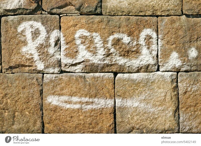 Peace. is written in white cursive on a sandstone wall / Peace. peace English tranquillity Blog Stone wall Symbols and metaphors Hope Peace Wish
