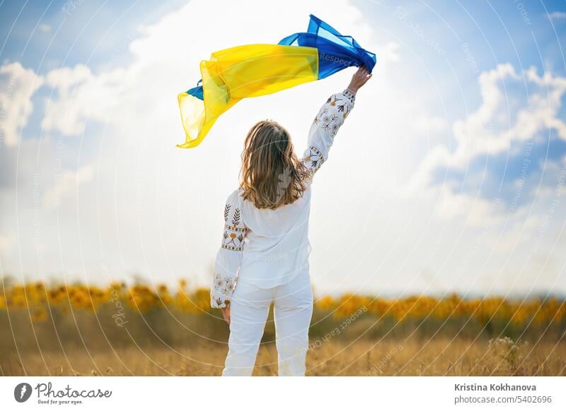 Happy ukrainian woman with national flag on summer sky background. freedom girl independence outdoors patriot patriotic patriotism symbol ukraine nationality