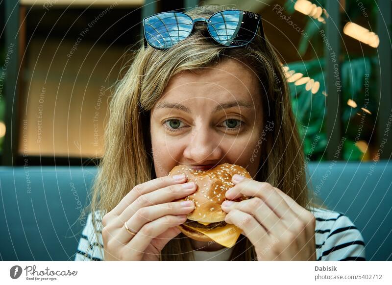 Woman eating burger, close up portrait hungry woman hamburger tasty food fast food nutritious bite adult attractive beautiful calories delicious face female
