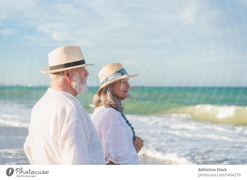 Romantic senior couple standing on beach romantic vacation love pensioner retire ocean calm together harmony summer seashore relationship seaside bonding travel