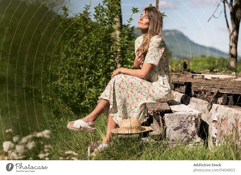 Relaxing woman sitting on porch in countryside sunlight enjoy summer leisure calm nature carefree eyes closed harmony tranquil freedom weekend quiet romantic