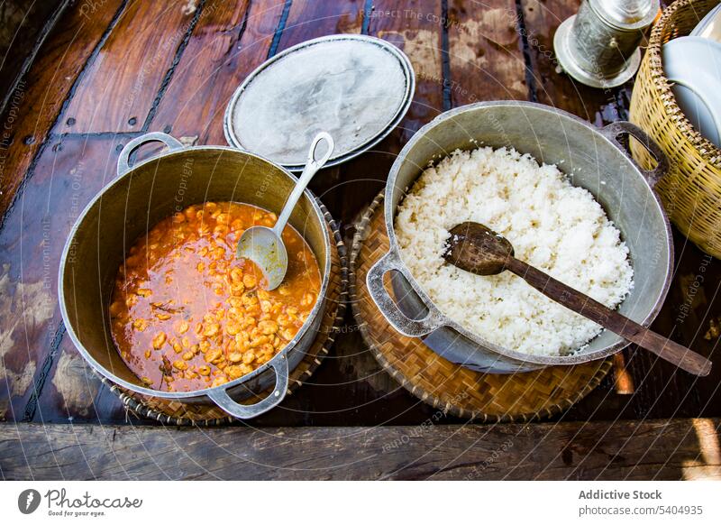 Traditional African vegetarian food on wooden table delicious bowl dish vegetable corn rice stew nutrition ceramic plate tasty meal serve cuisine organic fresh
