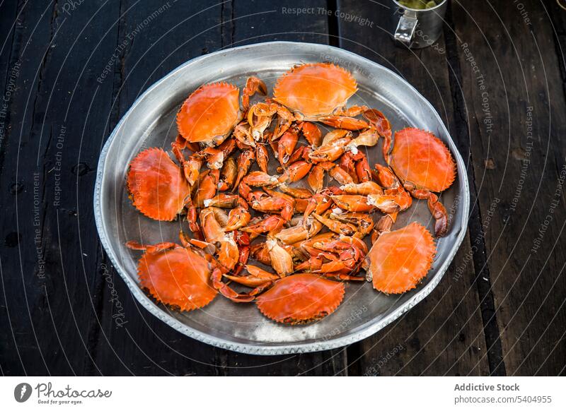Delicious and yummy seafood placed on wooden table crab leg delicious fresh tasty appetizing uncooked silver plate cuisine nutrition raw daylight surface dish
