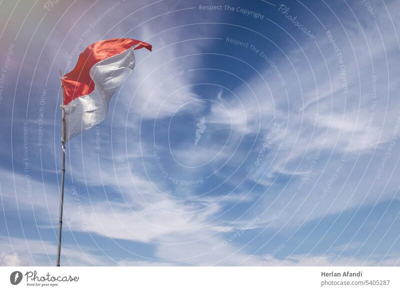 Flag of the republic indonesia with blue sky as background white isolated travel success holiday red symbol banner celebration freedom sign support world cloud