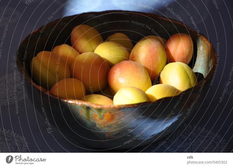 Turkish sugar apricots glow in the sunlight from a clay bowl on the table. Apricot Apricots Sugared apricots Fruit Delicious Fresh Food Colour photo Summer