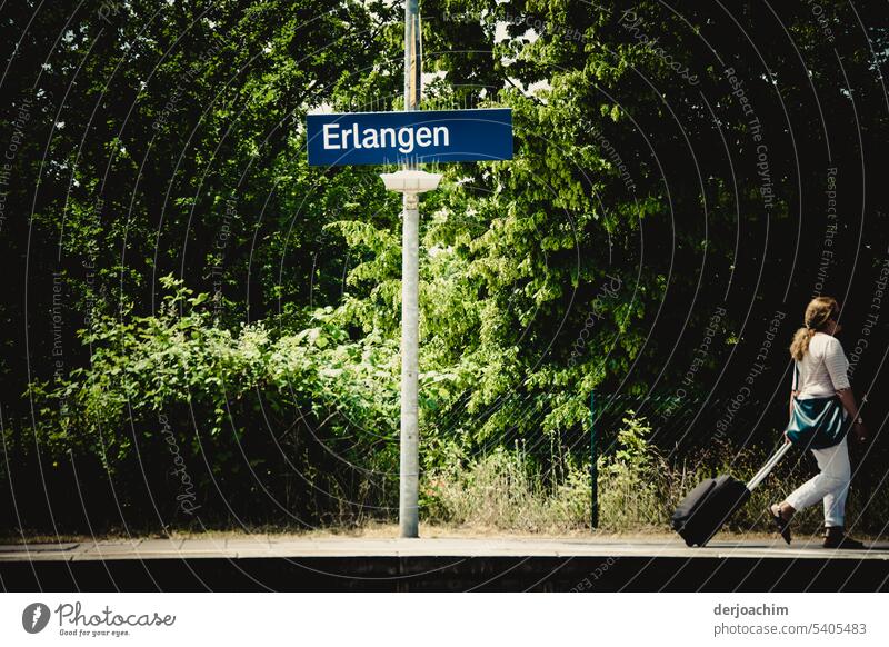 Destination reached. All get off. Erlangen A person walks to the exit with a rolling suitcase platform edge Railroad Movement Platform Human being Passenger