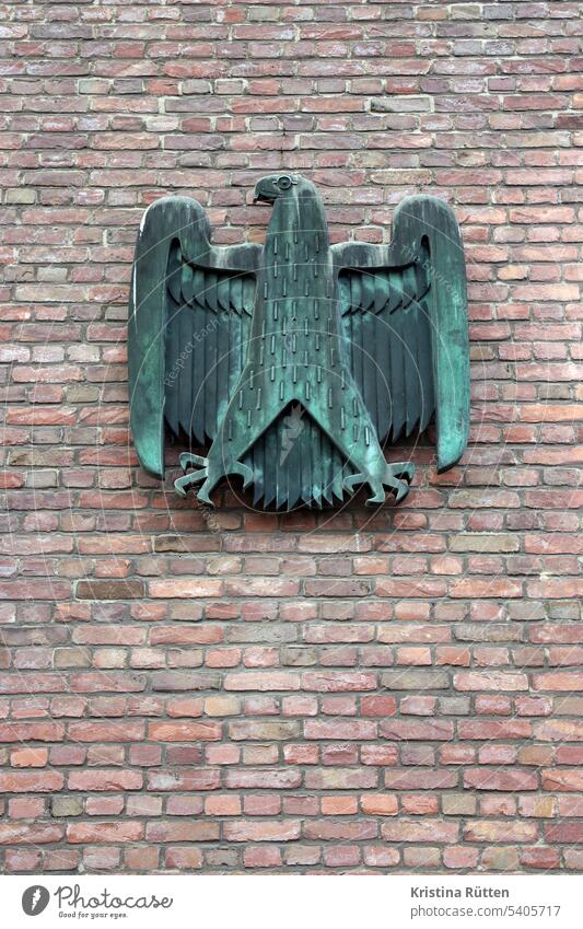 heraldic animal on brick wall Federal eagle Eagle Coat of arms Heraldic animal Logo symbol Bronze Building Facade Wall (building) Wall (barrier) Brick Germany