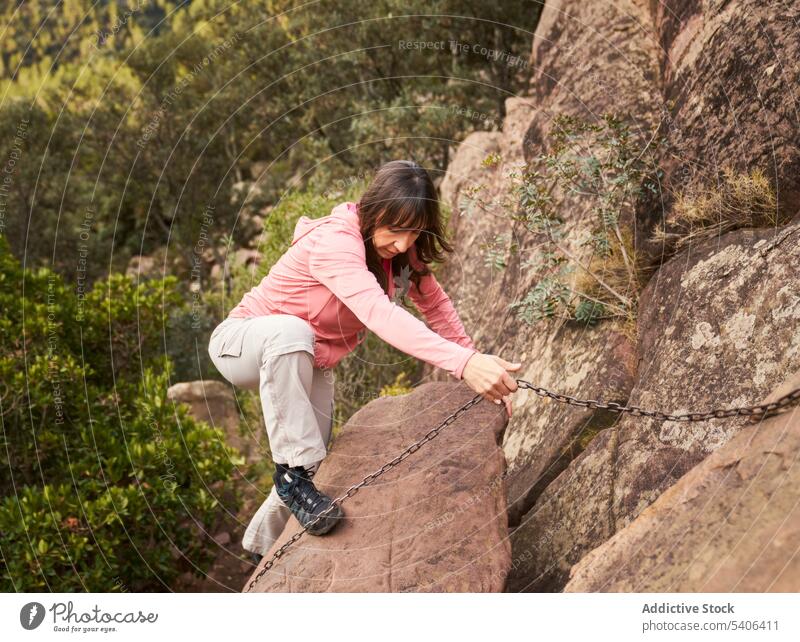 Lady climbing mountain in summer nature woman tourist ascend hike trip rocky chain formation female traveler explore vacation tourism lady trekking slope