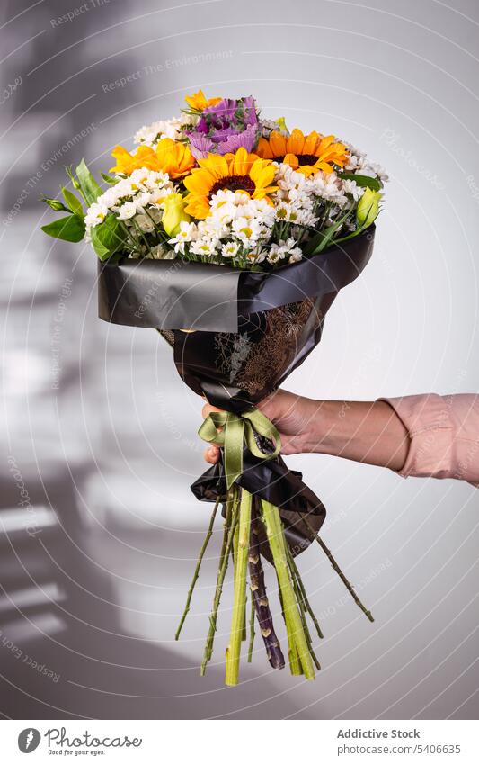 Crop woman with bouquet of flowers florist gift present bunch wrap aromatic flora bloom plant fresh floral style celebrate store floristry female lady botany