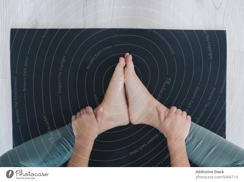 Legs of faceless barefoot person on mat during workout training yoga healthy lifestyle fitness equipment wellbeing exercise wellness physical supply activity