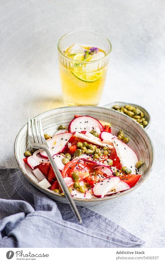 Vegetable salad with organic tomato with capers and lemonade bowl canned capparis cuisine dinner eat food fresh glass green healthy ice lime lunch meal mix