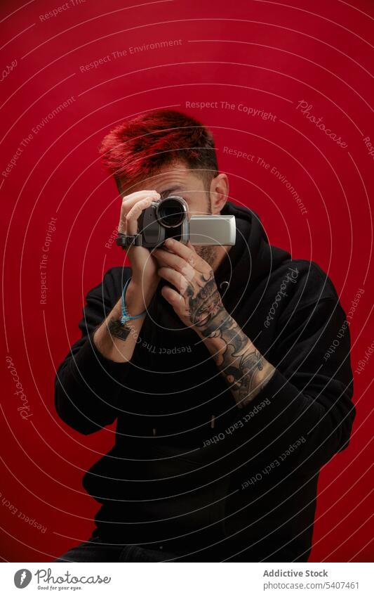 Unrecognizable young man taking shot on video camera shoot record using digital portrait gadget style modern amateur equipment vlog male device portable