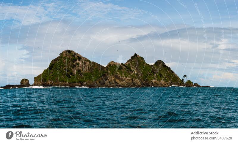 Rocky cliffs surrounded by rippling sea rocky wave aqua nature island water scenery exotic uvita puntarenas costa rica america tropical harmony growth stone