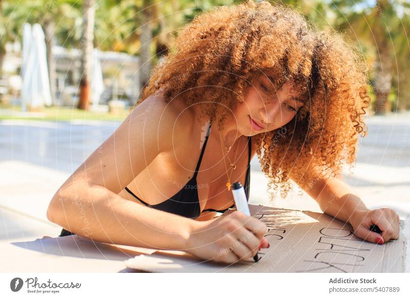 African American woman creating black lives matter poster protest demonstrate city marker pen writing no justice no peace activist female ethnic