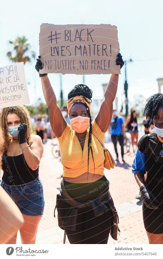 African American woman protesting with black lives matter poster demonstrate city clap crowd no justice no peace activist female ethnic african american people