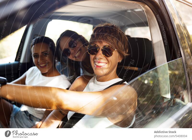 Women sitting in car and smiling at camera women friend cheerful friendship company summer enjoy weekend people friendly automobile optimist glad together