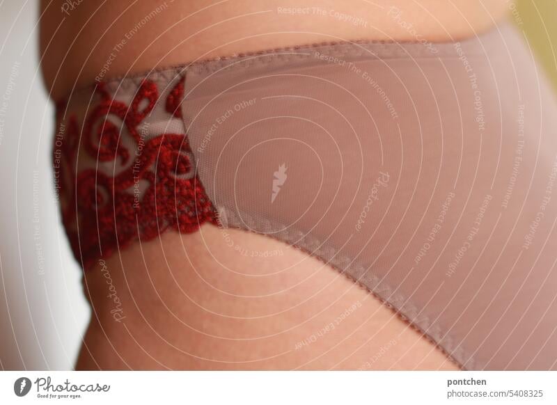 close up. a female body in a slip of fishnet. lingerie. skin with stretch  marks. - a Royalty Free Stock Photo from Photocase