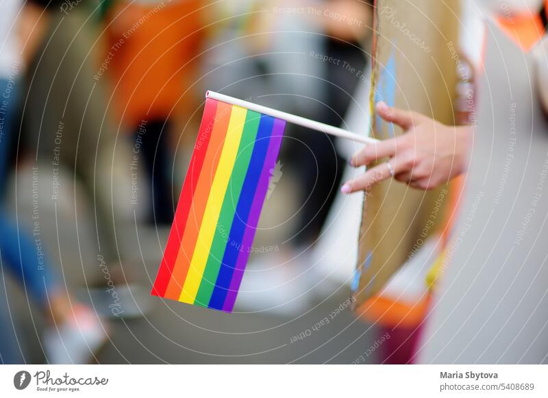 Activist holding rainbow flag and banner on the march on the city street during the Lgbt Pride Parade. Fighting for equality os sexual minorities. lgbtq pride