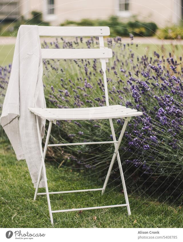 white garden chair with a cardigan by lavender provence white chair bistro chair outside outside seating sitting outside casual country living country life