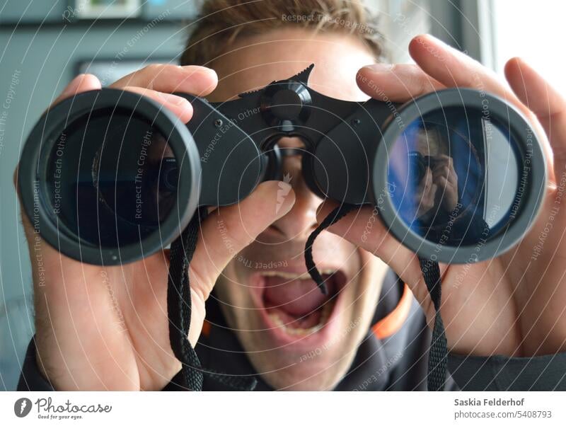 Looking through binoculars person man portrait face indoors point of view viewpoint magnify lens glasses eyes vision optical looking human human being