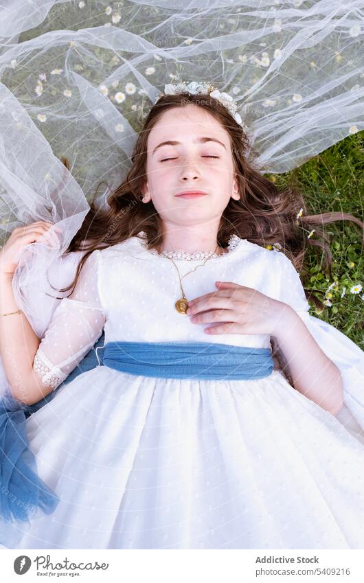 Teen girl in dress and veil dreaming on grass princess garden nymph charming nature child relax rest adorable peaceful teen innocent cute park calm childhood