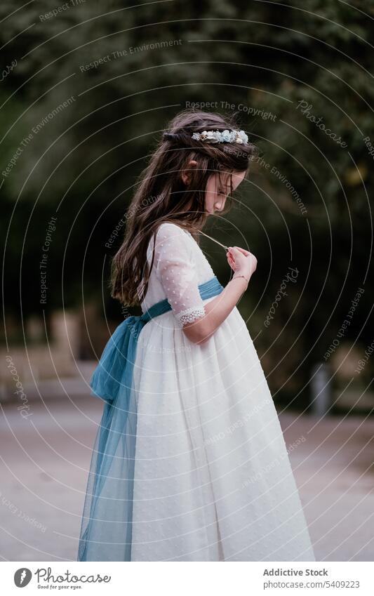 Girl in white dress and wreath looking at pendant girl park princess charming palace teen adorable alone daylight innocent style nature stand royal appearance