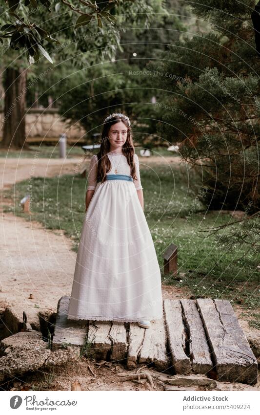 Elegant girl in white dress standing in park princess palace charming fancy nature romantic elegant appearance garden apparel smile outfit royal calm gentle
