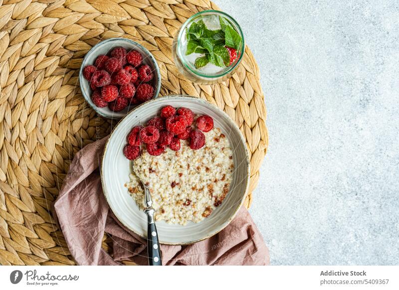 Healthy breakfast with oats oatmeal raspberries seed food delicious healthy organic eating diet ingredient culinary tasty cooked prepared dish bowl plate spoon