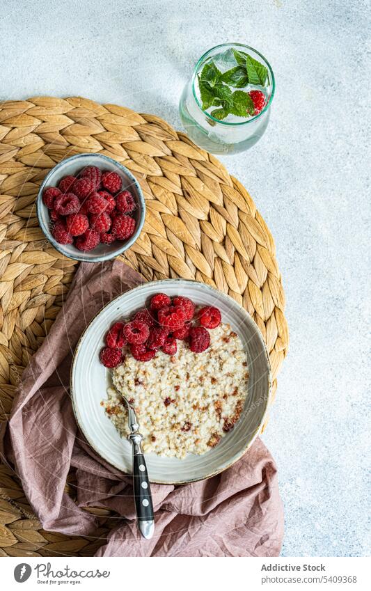 Healthy breakfast with oats oatmeal raspberries seed food delicious healthy organic eating diet ingredient culinary tasty cooked prepared dish bowl plate spoon