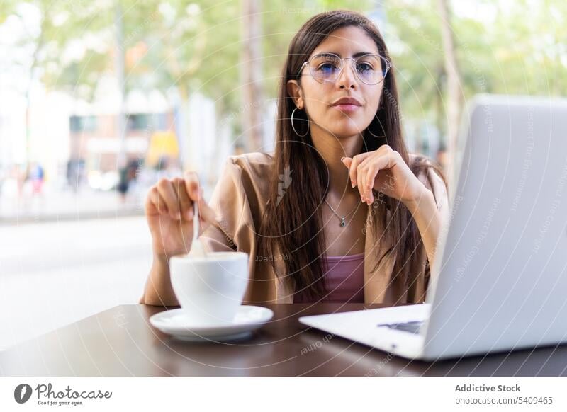 Focused woman working on laptop in cafe businesswoman entrepreneur concentrate thoughtful focus using typing netbook telework freelance Middle Eastern female