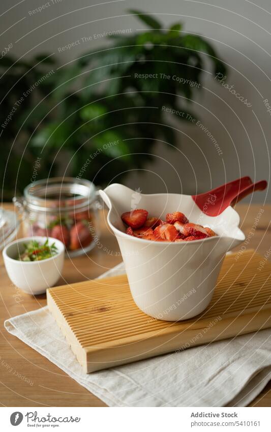 Sliced strawberries in bowl on table strawberry jam sweet delicious slice food dessert fresh cuisine wooden organic fabric natural glass yummy ingredient tasty