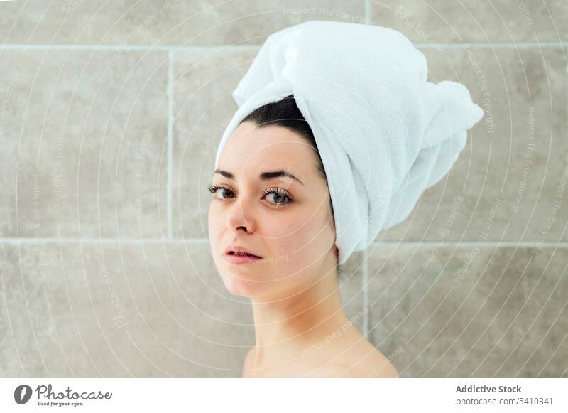 Young woman in head towel after shower bathroom hygiene wall home portrait style young appearance routine wear female charming apartment feminine attractive